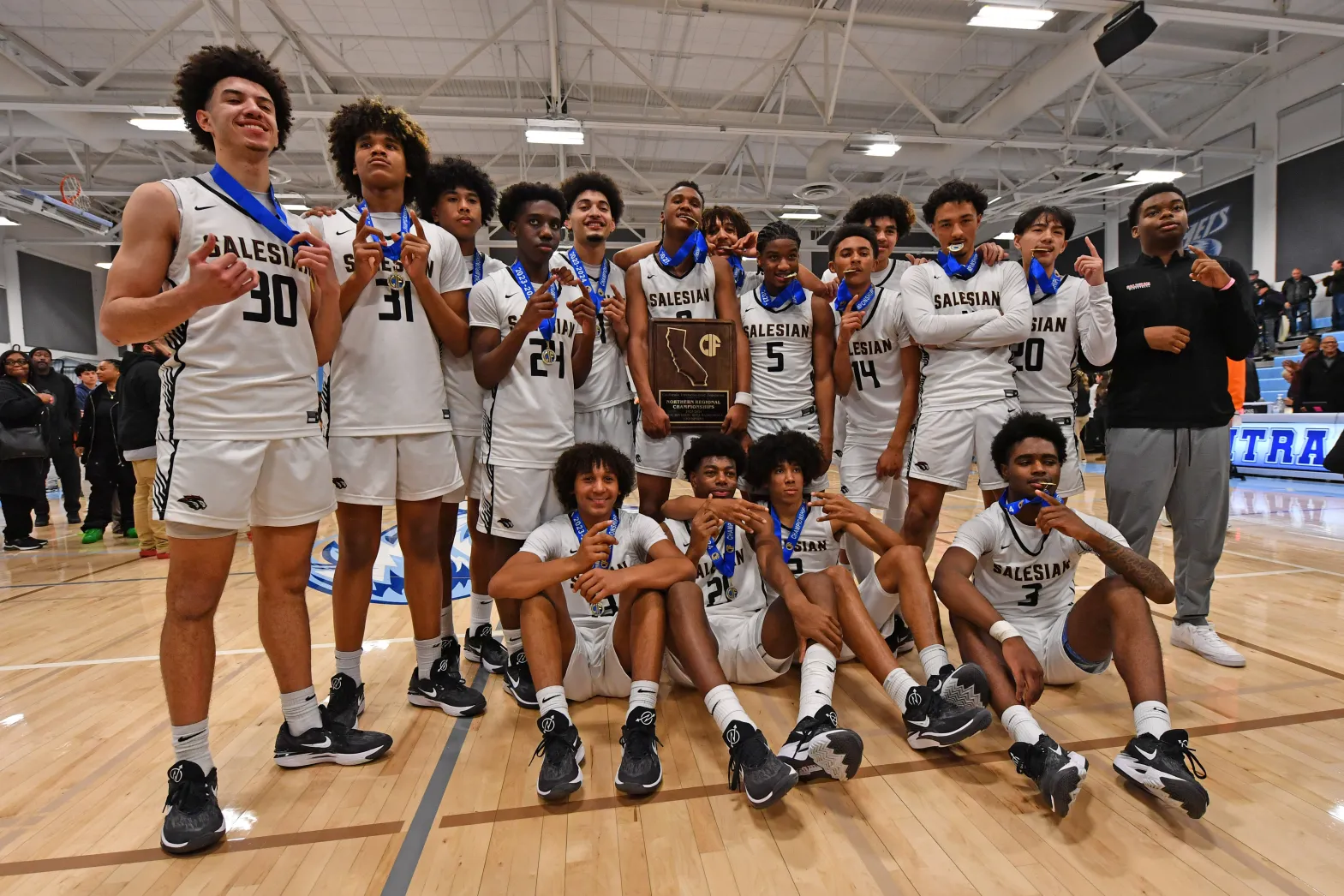 Salesian College Preparatory boys basketball team celebrating a CIF Northern Regional Championship.